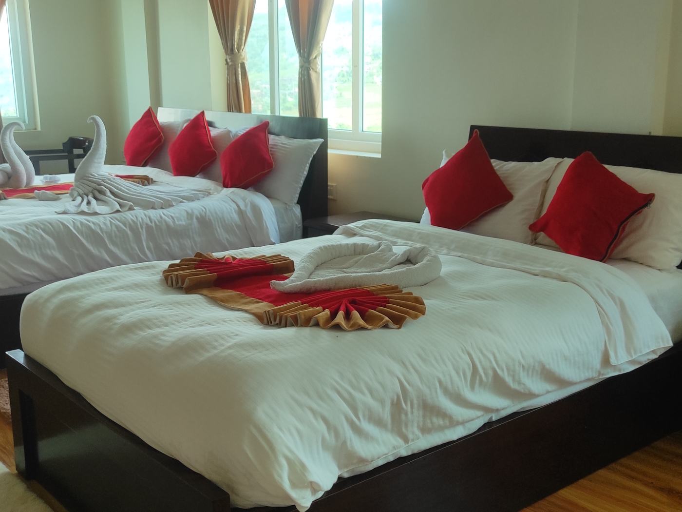 Two double beds in the family room, windows along the far wall